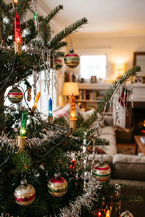 Real Christmas tree with old-fashioned bubble lights in red, green, blue and orange, tinsel icicles and striped glass ornaments