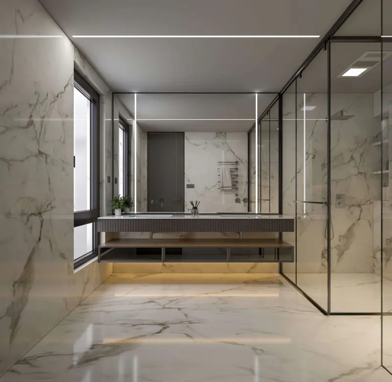 A luxurious bathroom with sleek marble stone flooring extending into the shower area.