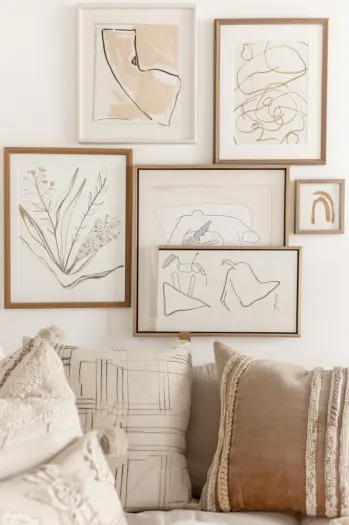 Boho bedroom, eclectic artwork, framed art, diverse styles.