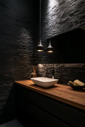 Japandi bathroom, black tiles, wooden accents, natural stone, ambient lighting.