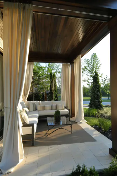 Modern front porch with white curtains, minimalistic furniture, and sleek design, creating a private and sophisticated outdoor living area