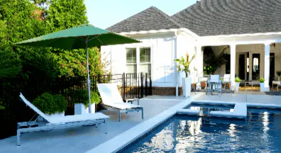 small pool with seating and umbrella providing shelter