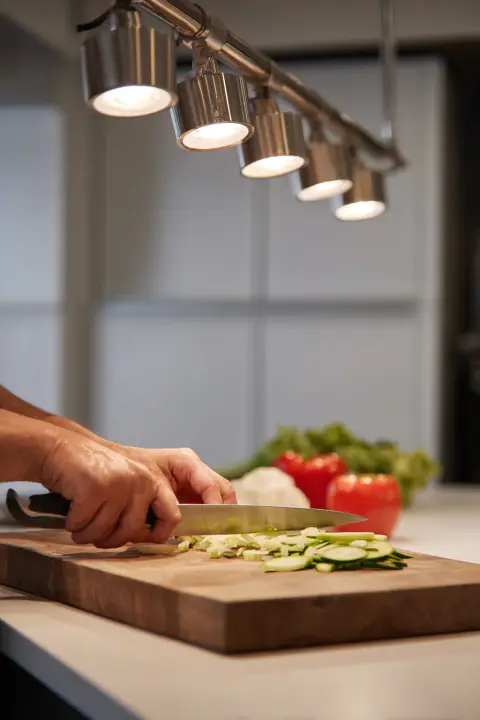 Functional and stylish kitchen spotlights on a track system providing direct LED light for a food preparation area. This showcases the versatility of modern kitchen ceiling lighting solutions for specific tasks.